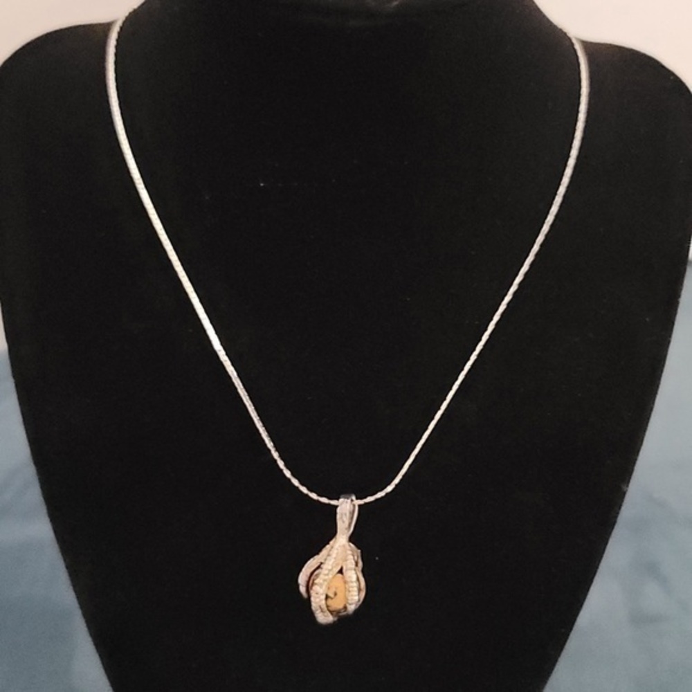Silver tone necklace claw holding marble
